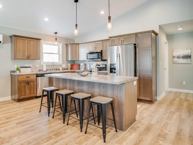 2855 28 11/16 St, Cedar Lake Twp, WI 54817 - kitchen featuring stainless steel appliances, a sink, a kitchen breakfast bar, a center island, and light wood finished floors