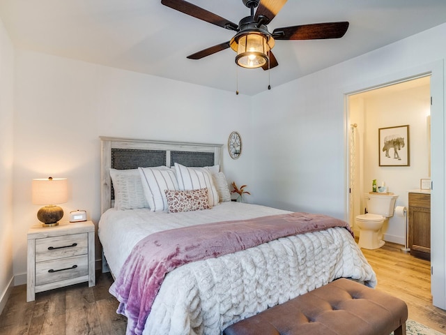 2855 28 11/16 St, Cedar Lake Twp, WI 54817 - bedroom with wood finished floors, baseboards, ensuite bathroom, and ceiling fan