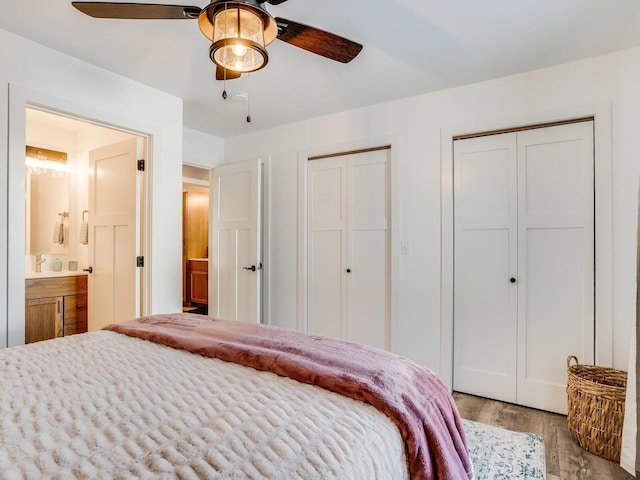 2855 28 11/16 St, Cedar Lake Twp, WI 54817 - bedroom with multiple closets, wood finished floors, ceiling fan, and connected bathroom