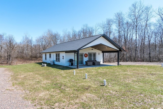 2855 28 11/16 St, Cedar Lake Twp, WI 54817 - view of front facade featuring ceiling fan, a front yard, a patio area, an outdoor hangout area, and a shingled roof