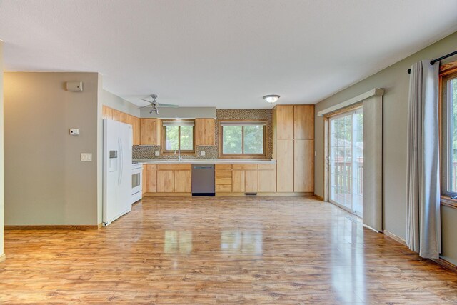 407 4th Ave NE, Kasson, MN 55944 - kitchen featuring white appliances, light wood-type flooring, light brown cabinets, and healthy amount of natural light