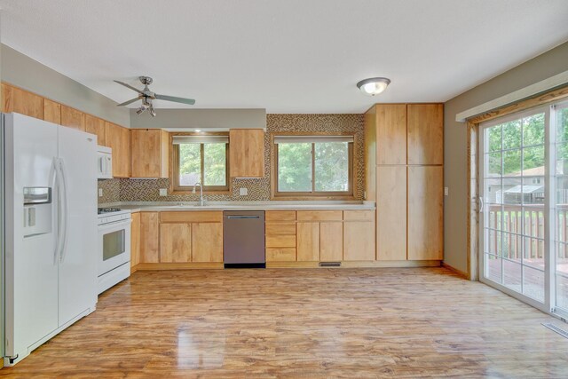 407 4th Ave NE, Kasson, MN 55944 - kitchen with white appliances, light countertops, tasteful backsplash, and light wood-style flooring