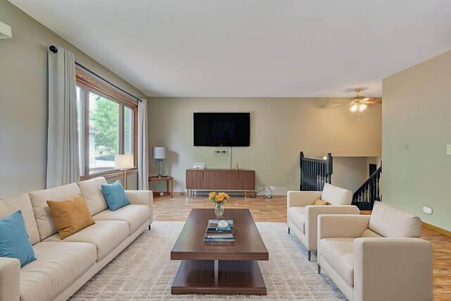 407 4th Ave NE, Kasson, MN 55944 - living room with ceiling fan, light wood-type flooring, and stairs