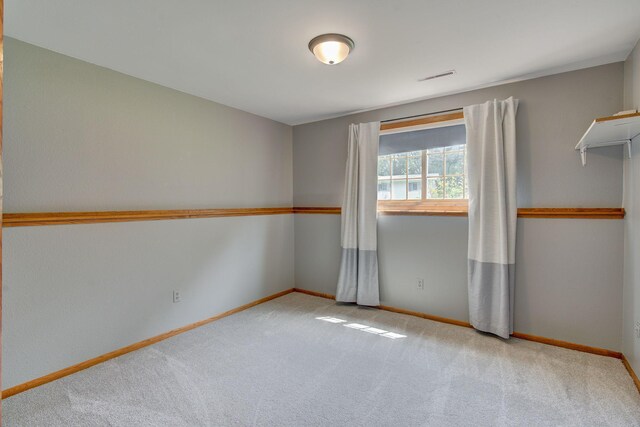 407 4th Ave NE, Kasson, MN 55944 - carpeted spare room featuring baseboards