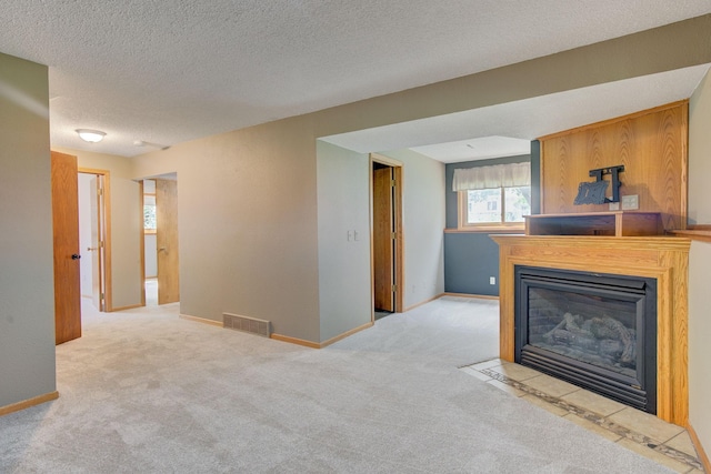 407 4th Ave NE, Kasson, MN 55944 - unfurnished living room featuring carpet, a fireplace with flush hearth, and a textured ceiling