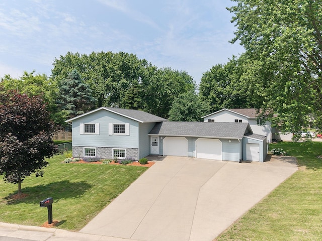 407 4th Ave NE, Kasson, MN 55944 - split level home featuring a garage, concrete driveway, a front lawn, and roof with shingles