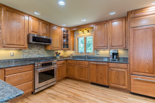 27766 County 37, Laporte, MN 56461 - kitchen featuring appliances with stainless steel finishes, a sink, brown cabinetry, light wood-style flooring, and recessed lighting