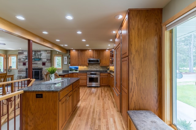 27766 County 37, Laporte, MN 56461 - kitchen with stainless steel appliances, brown cabinetry, light wood finished floors, recessed lighting, and plenty of natural light