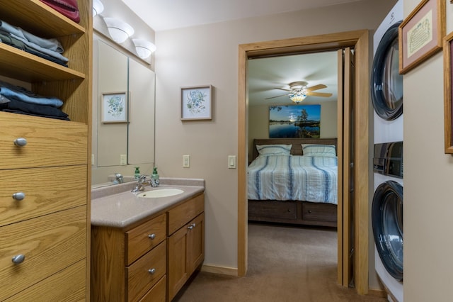 27766 County 37, Laporte, MN 56461 - ensuite bathroom with stacked washing machine and dryer, vanity, ceiling fan, and baseboards
