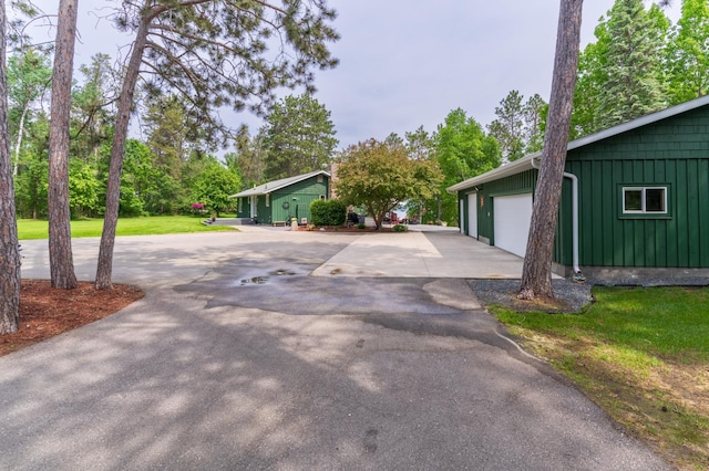 27766 County 37, Laporte, MN 56461 - view of front of house featuring board and batten siding, a garage, and view of wooded area