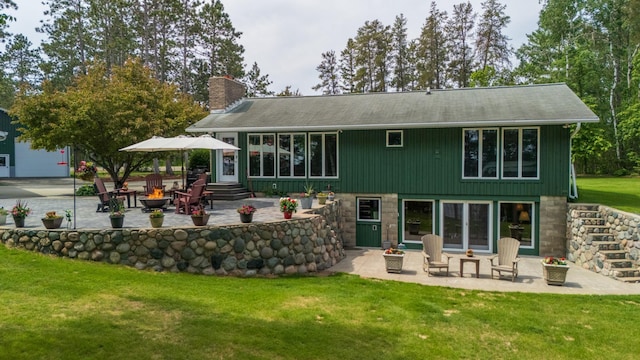 27766 County 37, Laporte, MN 56461 - back of house featuring an outdoor fire pit, a patio area, a chimney, and a yard