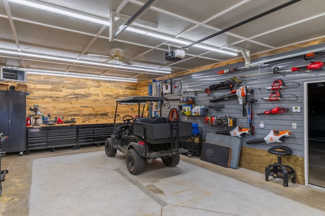 27766 County 37, Laporte, MN 56461 - garage featuring a workshop area, a garage door opener, and wooden walls