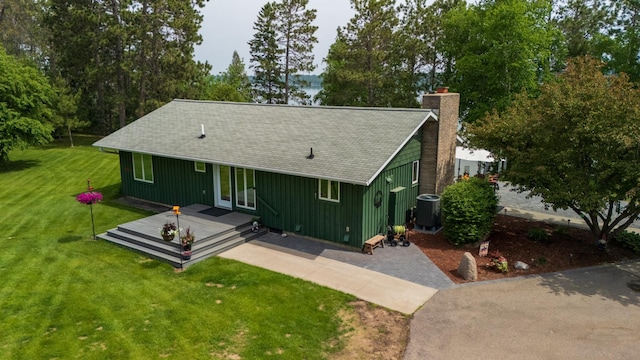 27766 County 37, Laporte, MN 56461 - rustic home with a deck, a chimney, a front yard, board and batten siding, and roof with shingles