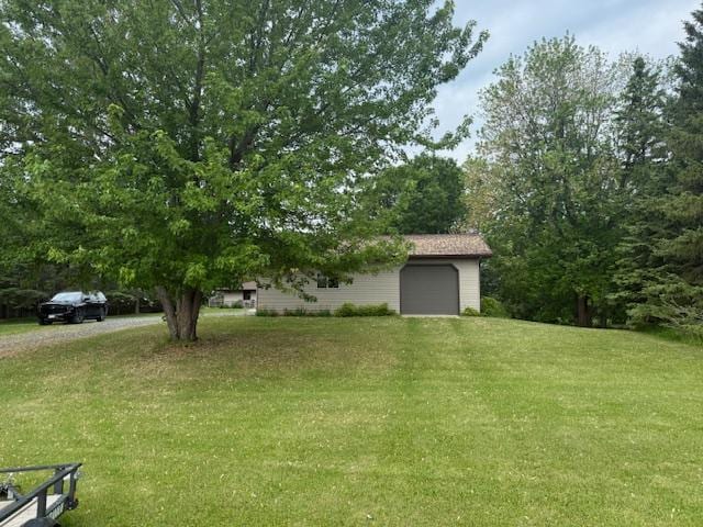20501 Nebish Rd NE, Blackduck, MN 56630 - view of green lawn with an attached garage and dirt driveway