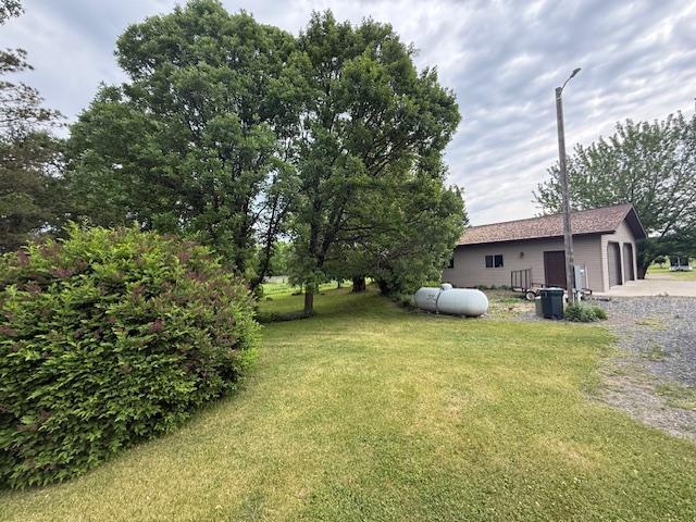 20501 Nebish Rd NE, Blackduck, MN 56630 - view of green lawn featuring an attached garage
