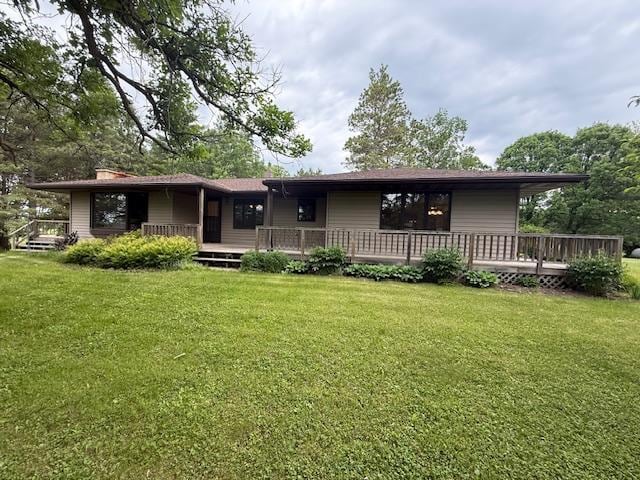 20501 Nebish Rd NE, Blackduck, MN 56630 - rear view of property featuring a lawn, a wooden deck, and a chimney
