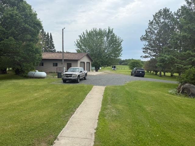 20501 Nebish Rd NE, Blackduck, MN 56630 - view of grassy yard featuring a garage and driveway