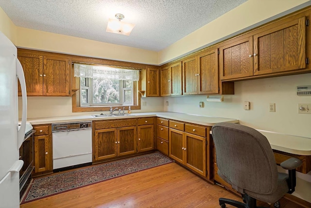 11606 235th St E, Lakeville, MN 55044 - kitchen with white appliances, a sink, brown cabinets, and a textured ceiling