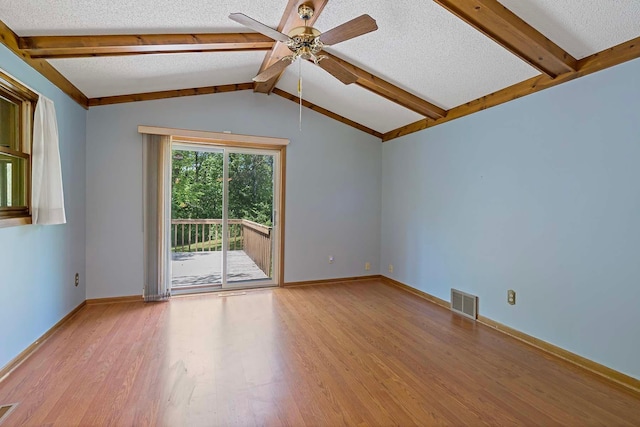 11606 235th St E, Lakeville, MN 55044 - empty room with wood finished floors, a ceiling fan, a textured ceiling, and baseboards