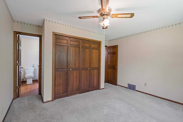 11606 235th St E, Lakeville, MN 55044 - unfurnished bedroom with light colored carpet, a closet, a textured ceiling, baseboards, and ceiling fan