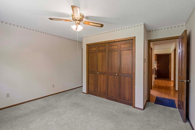 11606 235th St E, Lakeville, MN 55044 - unfurnished bedroom with light carpet, a closet, a textured ceiling, baseboards, and ceiling fan