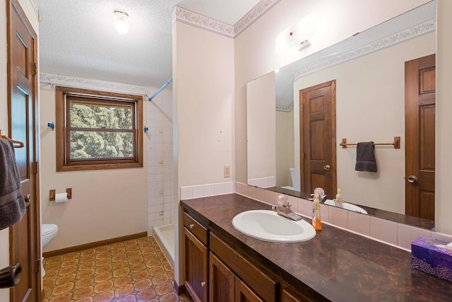11606 235th St E, Lakeville, MN 55044 - bathroom featuring toilet, vanity, tiled shower, and a textured ceiling