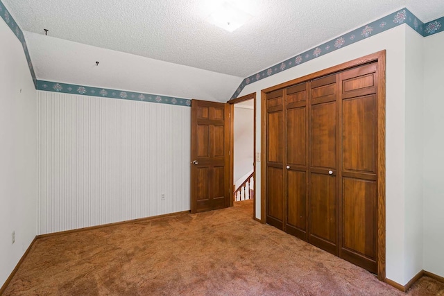 11606 235th St E, Lakeville, MN 55044 - unfurnished bedroom featuring a textured ceiling, carpet floors, a closet, wallpapered walls, and baseboards