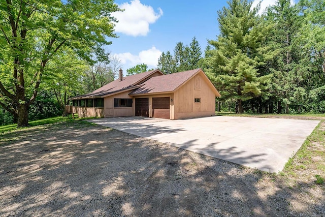 11606 235th St E, Lakeville, MN 55044 - view of home's exterior with a chimney, driveway, a garage, and roof with shingles
