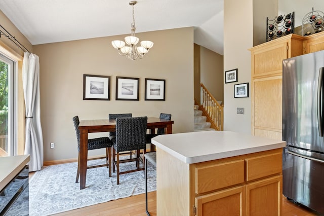 6449 151st St N, Hugo, MN 55038 - kitchen featuring freestanding refrigerator, vaulted ceiling, light wood finished floors, a chandelier, and light countertops