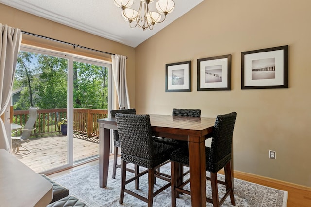 6449 151st St N, Hugo, MN 55038 - dining room featuring a chandelier, lofted ceiling, wood finished floors, and baseboards