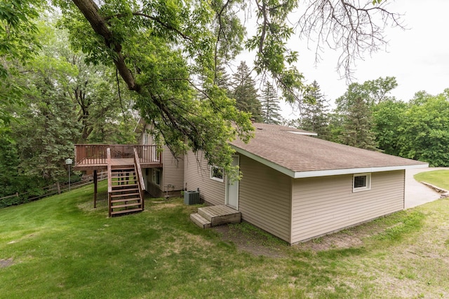 20619 Hillcrest Rd, Elizabeth Twp, MN 56537 - back of house featuring stairs, a deck, a lawn, a shingled roof, and central AC unit