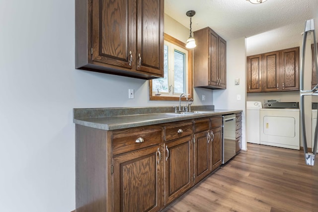 20619 Hillcrest Rd, Elizabeth Twp, MN 56537 - kitchen featuring independent washer and dryer, a sink, stainless steel dishwasher, wood finished floors, and pendant lighting