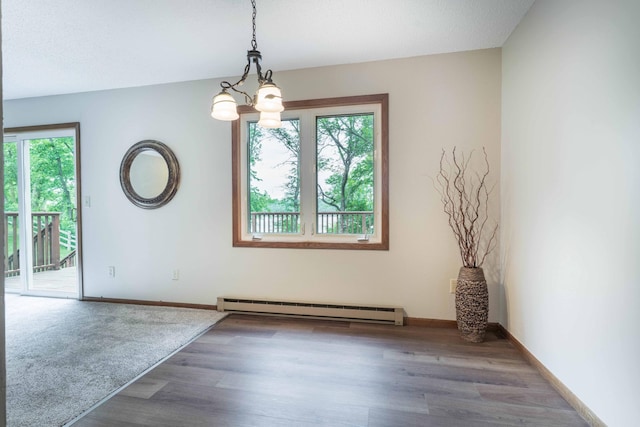 20619 Hillcrest Rd, Elizabeth Twp, MN 56537 - unfurnished dining area with baseboard heating, a chandelier, wood finished floors, and baseboards