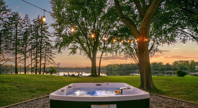2311 Swan Dr, Mendota Heights, MN 55120 - yard at dusk featuring a water view, a hot tub, and a lawn