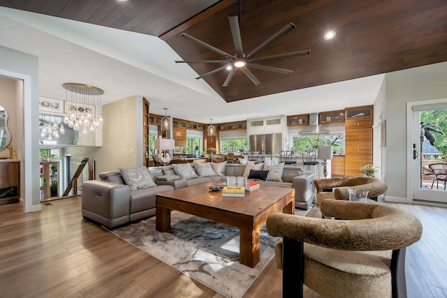 2311 Swan Dr, Mendota Heights, MN 55120 - living room featuring vaulted ceiling, ceiling fan, wood finished floors, baseboards, and a chandelier