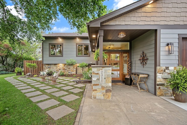 2311 Swan Dr, Mendota Heights, MN 55120 - view of exterior entry featuring a patio and stone siding