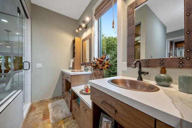 2311 Swan Dr, Mendota Heights, MN 55120 - bathroom with stone tile floors, two vanities, and a shower stall