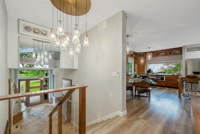 2311 Swan Dr, Mendota Heights, MN 55120 - hallway with a chandelier, baseboards, and wood finished floors