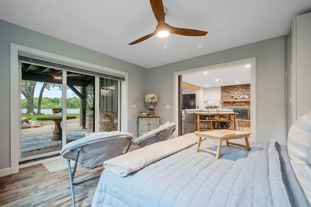 2311 Swan Dr, Mendota Heights, MN 55120 - bedroom with access to outside, light wood-style flooring, a large fireplace, a water view, and a ceiling fan