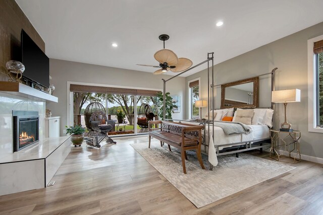 2311 Swan Dr, Mendota Heights, MN 55120 - bedroom featuring multiple windows, light wood finished floors, a fireplace, recessed lighting, and baseboards