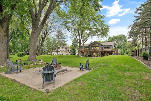 2311 Swan Dr, Mendota Heights, MN 55120 - view of grassy yard with an outdoor fire pit, a wooden deck, and a patio area