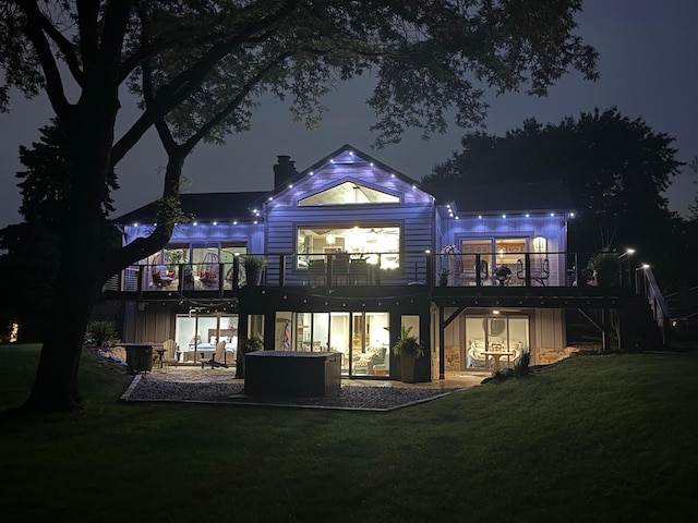 2311 Swan Dr, Mendota Heights, MN 55120 - back of house at twilight with a yard, a balcony, a patio, and a chimney