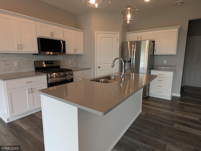 6785 104th St S, Cottage Grove, MN 55016 - kitchen with stainless steel appliances, backsplash, dark wood-style flooring, white cabinets, and an island with sink