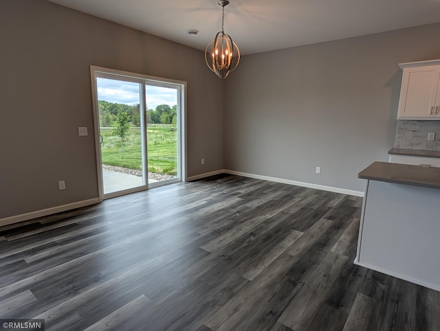 6785 104th St S, Cottage Grove, MN 55016 - unfurnished dining area featuring a chandelier and dark wood finished floors