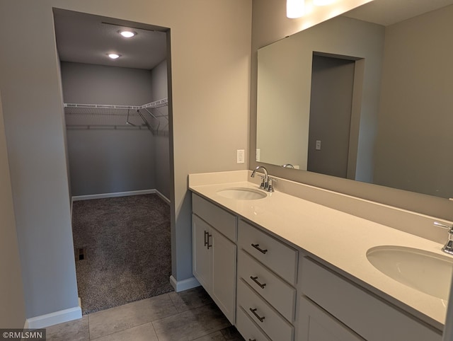 6785 104th St S, Cottage Grove, MN 55016 - bathroom featuring double vanity, tile patterned floors, and a spacious closet