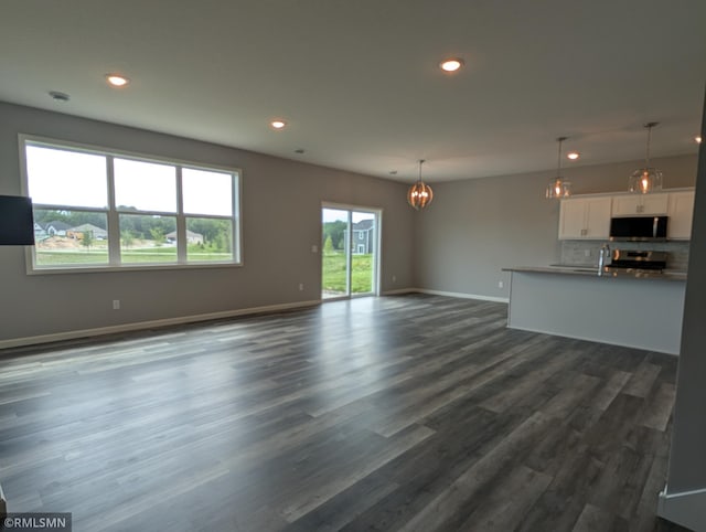 6785 104th St S, Cottage Grove, MN 55016 - unfurnished living room featuring a chandelier, recessed lighting, and dark wood-style flooring
