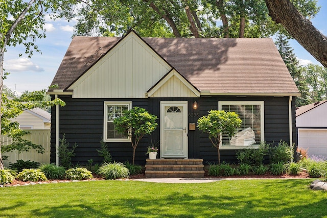 6233 4th Ave S, Richfield, MN 55423 - view of front of home with entry steps, a front lawn, a shingled roof, and an outdoor structure