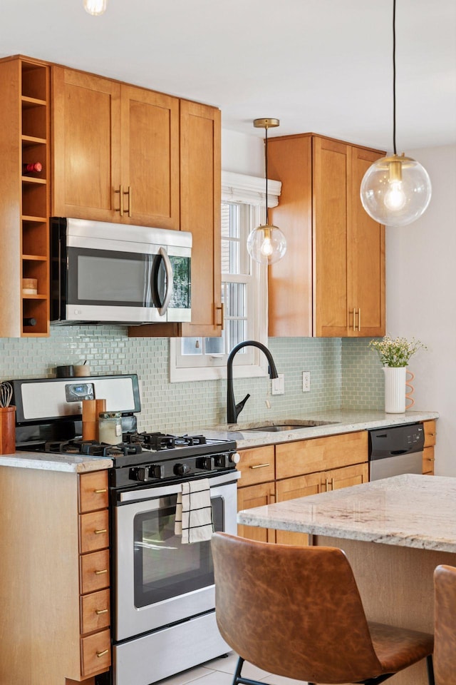 6233 4th Ave S, Richfield, MN 55423 - kitchen featuring stainless steel appliances, a sink, decorative backsplash, light stone countertops, and decorative light fixtures