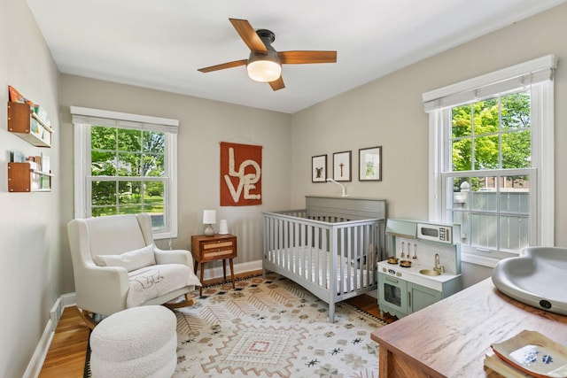 6233 4th Ave S, Richfield, MN 55423 - bedroom with baseboards, light wood-style flooring, and a ceiling fan