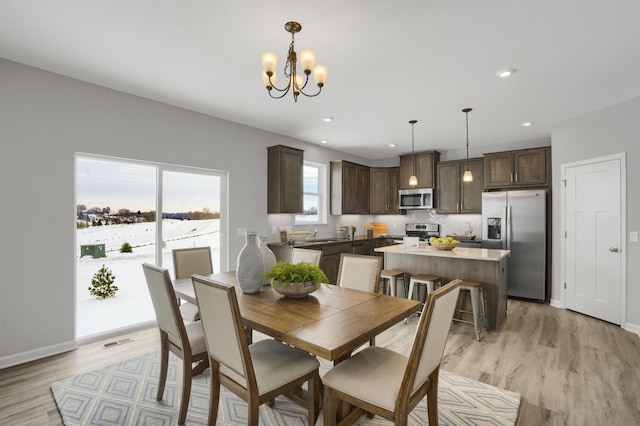 10647 29th St NE, Saint Michael, MN 55376 - dining area featuring a chandelier, light wood finished floors, recessed lighting, and baseboards